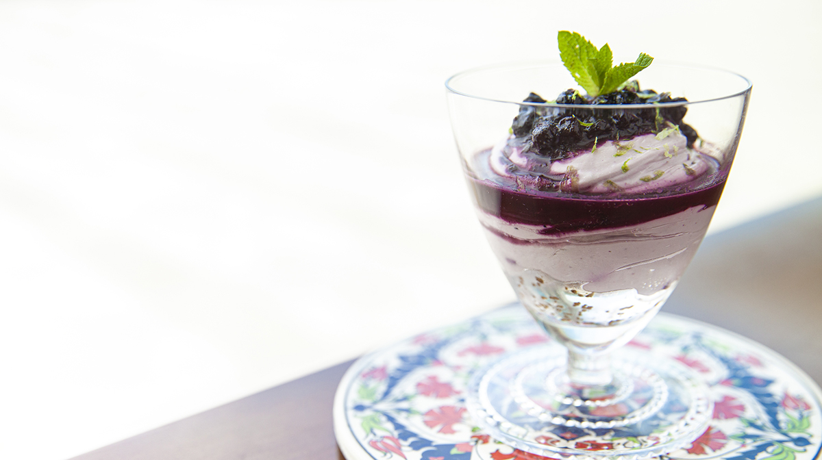 A citrus blueberry cheesecake parfait with ginger cookie crumbs.